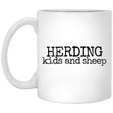 herding kids and sheep black Mugs