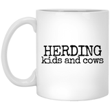 herding kids and cows black Mugs