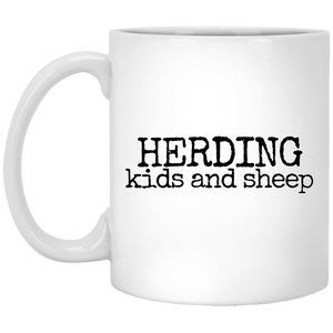 herding kids and sheep black Mugs